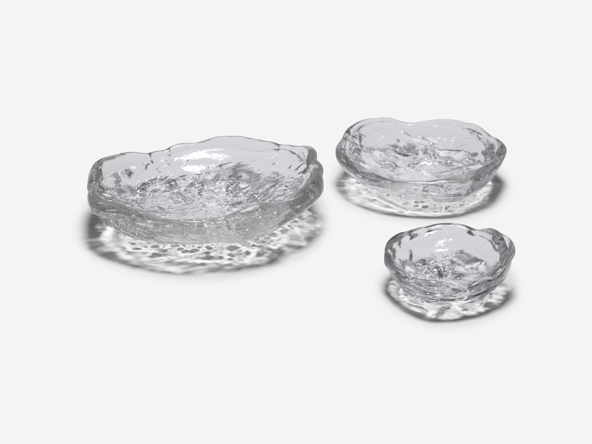 Front angle view of three different sized glass bowls